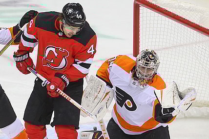 Jan 28, 2021; Newark, New Jersey, USA; Philadelphia Flyers goaltender Carter Hart (79) makes a glove save through a screen by New Jersey Devils left wing Miles Wood (44) during the second period at Prudential Center. Mandatory Credit: Ed Mulholland-USA TODAY Sports
