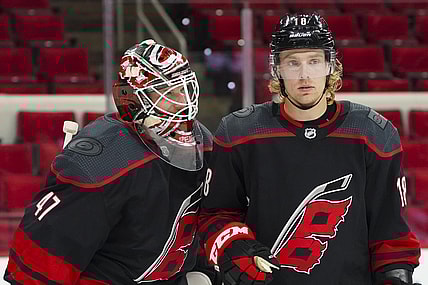 Jan 30, 2021; Raleigh, North Carolina, USA;  Carolina Hurricanes goaltender James Reimer (47) and center Ryan Dzingel (18) celebrate there win against the Dallas Stars at PNC Arena. Mandatory Credit: James Guillory-USA TODAY Sports