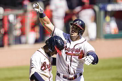 Oct 1, 2020; Cumberland, Georgia, USA; Atlanta Braves left fielder Adam Duvall (23) reacts with second baseman Ozzie Albies (1) after hitting a two run home run against the Cincinnati Reds during the eighth inning at Truist Park. Mandatory Credit: Dale Zanine-USA TODAY Sports