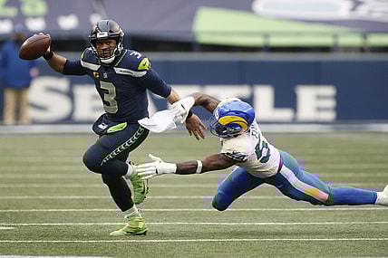 Jan 9, 2021; Seattle, Washington, USA; Seattle Seahawks quarterback Russell Wilson (3) avoids the tackle by Los Angeles Rams linebacker Leonard Floyd (54) during the third quarter at Lumen Field. Mandatory Credit: Joe Nicholson-USA TODAY Sports