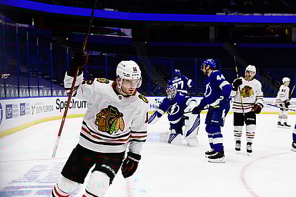 Jan 15, 2021; Tampa, Florida, USA; Chicago Blackhawks left wing Alex DeBrincat (12) reacts after scoring during the second period against the Tampa Bay Lightning at Amalie Arena. Mandatory Credit: Douglas DeFelice-USA TODAY Sports