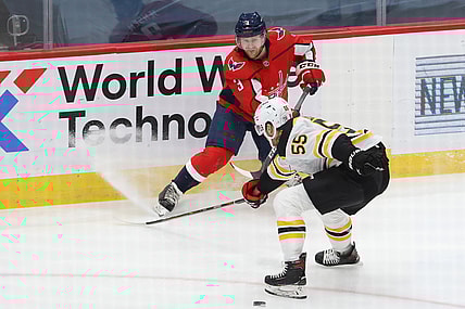 Feb 1, 2021; Washington, District of Columbia, USA; Washington Capitals defenseman Nick Jensen (3) passes the puck as Boston Bruins defenseman Jeremy Lauzon (55) defends in the first period at Capital One Arena. Mandatory Credit: Geoff Burke-USA TODAY Sports