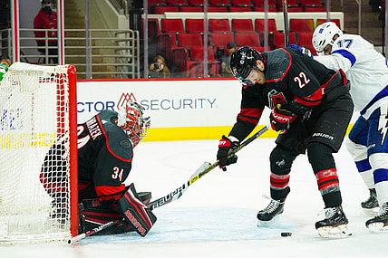 Jan 28, 2021; Raleigh, North Carolina, USA;  Carolina Hurricanes goaltender Petr Mrazek (34) and defenseman Brett Pesce (22) watch the puck against the Tampa Bay Lightning at PNC Arena. Mandatory Credit: James Guillory-USA TODAY Sports
