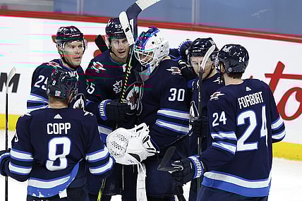 Feb 2, 2021; Winnipeg, Manitoba, CAN.;  Winnipeg Jets players celebrate their win against the Calgary Flames at Bell MTS Place. Mandatory Credit: James Carey Lauder-USA TODAY Sports