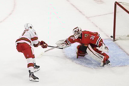 Feb 2, 2021; Chicago, Illinois, USA; Carolina Hurricanes right wing Andrei Svechnikov (37) scores a goal against Chicago Blackhawks goaltender Kevin Lankinen (32) during a shoot-out at United Center. Mandatory Credit: Kamil Krzaczynski-USA TODAY Sports