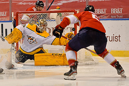 Feb 4, 2021; Sunrise, Florida, USA; Florida Panthers defenseman Aaron Ekblad (5) scores a goal past Nashville Predators goaltender Juuse Saros (74) during the second period at BB&T Center. Mandatory Credit: Jasen Vinlove-USA TODAY Sports