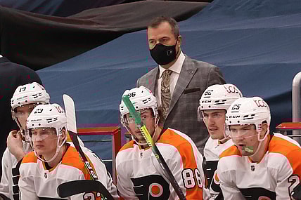 Feb 7, 2021; Washington, District of Columbia, USA; Philadelphia Flyers head coach Alain Vigneault (M) looks on from behind the bench against the Washington Capitals in the third period at Capital One Arena. Mandatory Credit: Geoff Burke-USA TODAY Sports