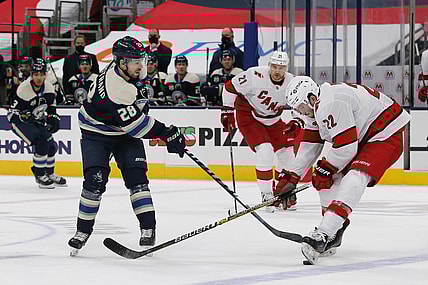 Feb 7, 2021; Columbus, Ohio, USA; Carolina Hurricanes defenseman Brett Pesce (22) knocks down the pass attempt of Columbus Blue Jackets right wing Oliver Bjorkstrand (28) during the first period at Nationwide Arena. Mandatory Credit: Russell LaBounty-USA TODAY Sports