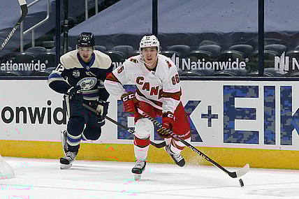 Feb 7, 2021; Columbus, Ohio, USA; Carolina Hurricanes left wing Teuvo Teravainen (86) carries the puck as Columbus Blue Jackets center Alexandre Texier (42) trails the play during the first period at Nationwide Arena. Mandatory Credit: Russell LaBounty-USA TODAY Sports