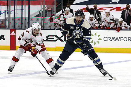 Feb 7, 2021; Columbus, Ohio, USA; Columbus Blue Jackets left wing Nick Foligno (71) looks to pass as Carolina Hurricanes right wing Sebastian Aho (20) pursues during the third period at Nationwide Arena. Mandatory Credit: Russell LaBounty-USA TODAY Sports