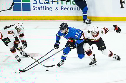 Feb 13, 2021; Winnipeg, Manitoba, CAN;  Winnipeg Jets forward Nikolaj Ehlers (27) battles Ottawa Senators forward Nick Paul (13) and forward Evgeni Dadonov (63) for the puck during the first period at Bell MTS Place. Mandatory Credit: Terrence Lee-USA TODAY Sports