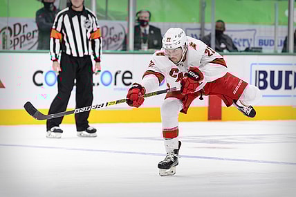 Feb 13, 2021; Dallas, Texas, USA; Carolina Hurricanes defenseman Brett Pesce (22) shoots the puck in the Dallas Stars zone during the third period at the American Airlines Center. Mandatory Credit: Jerome Miron-USA TODAY Sports