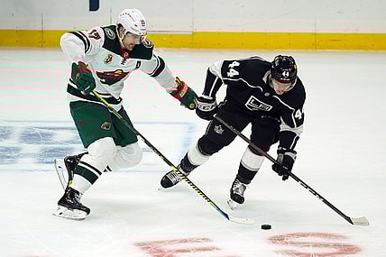 Feb 16, 2021; Los Angeles, California, USA; Minnesota Wild left wing Marcus Foligno (17) and LA Kings defenseman Mikey Anderson (44) battle for the puck in the first period at Staples Center. Mandatory Credit: Kirby Lee-USA TODAY Sports