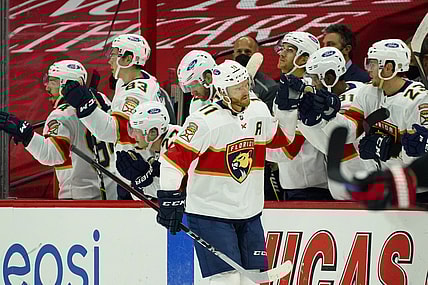 Feb 17, 2021; Raleigh, North Carolina, USA;  Florida Panthers left wing Jonathan Huberdeau (11) is congratulated after scoring a goal against the Carolina Hurricanes during the second period at PNC Arena. Mandatory Credit: James Guillory-USA TODAY Sports