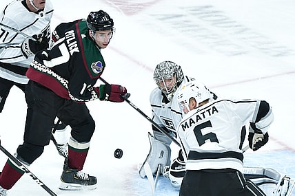 Feb 18, 2021; Glendale, Arizona, USA; Arizona Coyotes center Tyler Pitlick (17), z5 and goaltender Jonathan Quick (32) watch a rebounding puck during the first period  at Gila River Arena. Mandatory Credit: Matt Kartozian-USA TODAY Sports