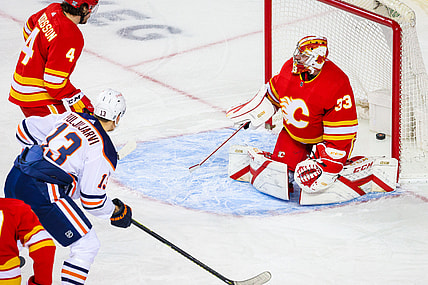 Feb 19, 2021; Calgary, Alberta, CAN; Calgary Flames goaltender David Rittich (33) reacts as Edmonton Oilers right wing Jesse Puljujarvi (13) scores a goal during the first period at Scotiabank Saddledome. Mandatory Credit: Sergei Belski-USA TODAY Sports