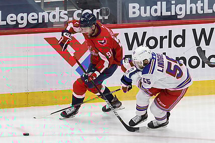 Feb 20, 2021; Washington, District of Columbia, USA; Washington Capitals center Evgeny Kuznetsov (92). Skates with the puck as New York Rangers defenseman Ryan Lindgren (55) defends in the first period at Capital One Arena. Mandatory Credit: Geoff Burke-USA TODAY Sports