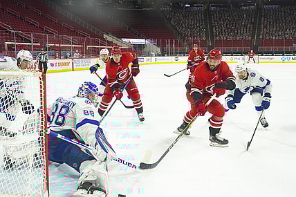 Feb 22, 2021; Raleigh, North Carolina, USA;  Tampa Bay Lightning goaltender Andrei Vasilevskiy (88) stops the shot against Carolina Hurricanes center Vincent Trocheck (16) at PNC Arena. Mandatory Credit: James Guillory-USA TODAY Sports