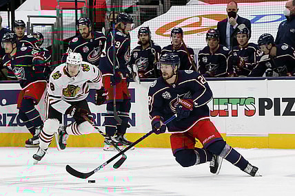 Feb 25, 2021; Columbus, Ohio, USA; Columbus Blue Jackets right wing Oliver Bjorkstrand (28) grabs a loose puck against the Chicago Blackhawks during the first period at Nationwide Arena. Mandatory Credit: Russell LaBounty-USA TODAY Sports