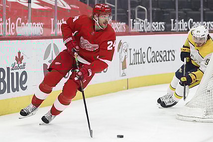 Feb 25, 2021; Detroit, Michigan, USA; Detroit Red Wings defenseman Jon Merrill (24) skates away from Nashville Predators center Matt Duchene (95) during the first period at Little Caesars Arena. Mandatory Credit: Raj Mehta-USA TODAY Sports