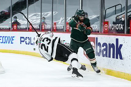 Feb 26, 2021; Saint Paul, Minnesota, USA; Minnesota Wild defenseman Matt Dumba (24) checks Los Angeles Kings right wing Dustin Brown (23) in the third period at Xcel Energy Center. Mandatory Credit: David Berding-USA TODAY Sports