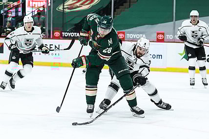 Feb 26, 2021; Saint Paul, Minnesota, USA; Minnesota Wild defenseman Ian Cole (28) and Los Angeles Kings defenseman Drew Doughty (8) battle for the puck in the second period at Xcel Energy Center. Mandatory Credit: David Berding-USA TODAY Sports