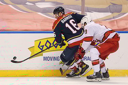 Feb 27, 2021; Sunrise, Florida, USA; Florida Panthers center Aleksander Barkov (16) controls the puck around Carolina Hurricanes defenseman Brett Pesce (22) during the second period at BB&T Center. Mandatory Credit: Sam Navarro-USA TODAY Sports