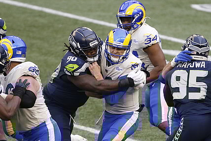Jan 9, 2021; Seattle, Washington, USA; Seattle Seahawks defensive tackle Jarran Reed (90) sacks Los Angeles Rams quarterback Jared Goff (16) during the third quarter at Lumen Field. Mandatory Credit: Joe Nicholson-USA TODAY Sports