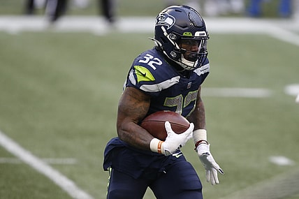 Jan 9, 2021; Seattle, Washington, USA; Seattle Seahawks running back Chris Carson (32) runs the ball against the Los Angeles Rams during the third quarter at Lumen Field. Mandatory Credit: Joe Nicholson-USA TODAY Sports