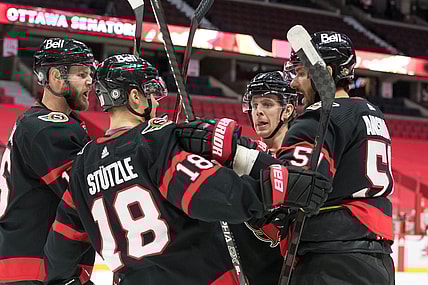 Mar 1, 2021; Ottawa, Ontario, CAN; The  Ottawa Senators celebrate after a goal by center Artem Anisimov (right) the Calgary Flames in the second period against at the Canadian Tire Centre. Mandatory Credit: Marc DesRosiers-USA TODAY Sports