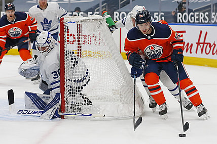 Mar 1, 2021; Edmonton, Alberta, CAN; Edmonton Oilers forward Kailer Yamamoto (56) moves the puck behind Toronto Maple Leafs goaltender Michael Hutchinson (30) during the third period at Rogers Place. Mandatory Credit: Perry Nelson-USA TODAY Sports