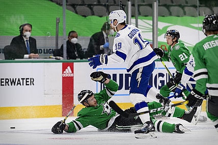Mar 2, 2021; Dallas, Texas, USA; Dallas Stars defenseman Jamie Oleksiak (2) is tripped up by Tampa Bay Lightning center Barclay Goodrow (19) during the first period at the American Airlines Center. Mandatory Credit: Jerome Miron-USA TODAY Sports