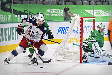 Mar 4, 2021; Dallas, Texas, USA; Columbus Blue Jackets center Boone Jenner (38) skates against the Stars as Dallas Stars goaltender Anton Khudobin (35) defends the goal during the first period at the American Airlines Center. Mandatory Credit: Jerome Miron-USA TODAY Sports