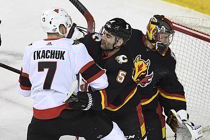 Mar 4, 2021; Calgary, Alberta, CAN; Ottawa Senators forward Brady Tkachuk (7) battles with Calgary Flames defenseman Mark Giordano (5) during the first period  at Scotiabank Saddledome. Mandatory Credit: Candice Ward-USA TODAY Sports