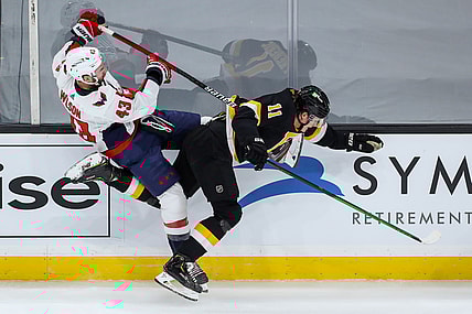 Mar 5, 2021; Boston, Massachusetts, USA; Washington Capitals right wing Tom Wilson (43) checks Boston Bruins center Trent Frederic (11) during the first period at TD Garden. Mandatory Credit: Paul Rutherford-USA TODAY Sports