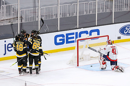 Mar 5, 2021; Boston, Massachusetts, USA; The Boston Bruins celebrate after a goal by left wing Brad Marchand (63) against Washington Capitals goalie Vitek Vanecek (41) during the second period at TD Garden. Mandatory Credit: Paul Rutherford-USA TODAY Sports