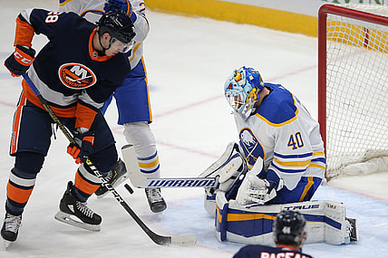 Mar 6, 2021; Uniondale, New York, USA; Buffalo Sabres goalie Carter Hutton (40) makes a save against New York Islanders left wing Michael Dal Colle (28) during the first period at Nassau Veterans Memorial Coliseum. Mandatory Credit: Brad Penner-USA TODAY Sports