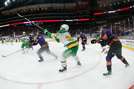 Mar 6, 2021; Glendale, Arizona, USA; Minnesota Wild left wing Kevin Fiala (22) bats down a puck against the Arizona Coyotes during the second period at Gila River Arena. Mandatory Credit: Joe Camporeale-USA TODAY Sports