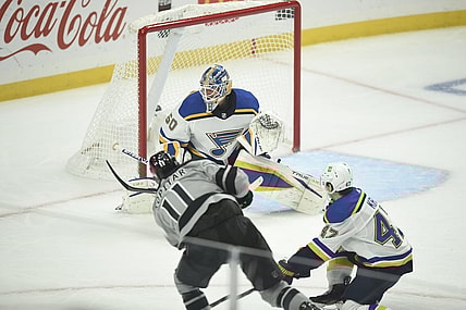 Mar 6, 2021; Los Angeles, California, USA; Los Angeles Kings center Anze Kopitar (11) shoots to score a goal past St. Louis Blues goalie Jordan Binnington (50) as defenseman Torey Krug (47) looks on during the first period at Staples Center. Mandatory Credit: Kelvin Kuo-USA TODAY Sports