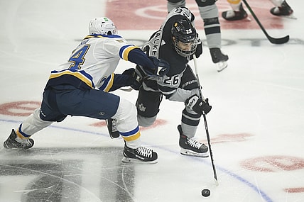 Mar 6, 2021; Los Angeles, California, USA; Los Angeles Kings defenseman Sean Walker (26) moves the puck while defended by St. Louis Blues center Dakota Joshua (54) during the first period at Staples Center. Mandatory Credit: Kelvin Kuo-USA TODAY Sports