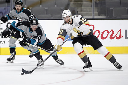 Mar 6, 2021; San Jose, California, USA; Vegas Golden Knights center Nicolas Roy (10) reaches for the puck against San Jose Sharks defenseman Nikolai Knyzhov (71) during the second period at SAP Center at San Jose. Mandatory Credit: Darren Yamashita-USA TODAY Sports