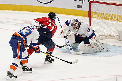 Mar 16, 2021; Washington, District of Columbia, USA;  New York Islanders goaltender Semyon Varlamov (40) makes a save on Washington Capitals right wing Garnet Hathaway (21) as Islanders center Mathew Barzal (13) defends in the second period at Capital One Arena. Mandatory Credit: Geoff Burke-USA TODAY Sports