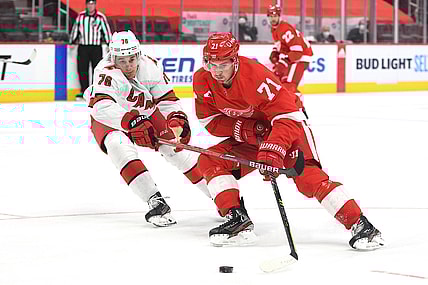 Mar 16, 2021; Detroit, Michigan, USA; Detroit Red Wings center Dylan Larkin (71) skates the puck up ice against Carolina Hurricanes defenseman Brady Skjei (76) during the second period at Little Caesars Arena. Mandatory Credit: Tim Fuller-USA TODAY Sports
