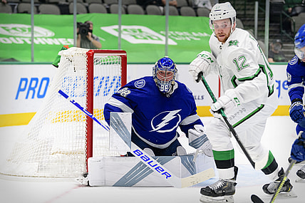 Mar 16, 2021; Dallas, Texas, USA; Tampa Bay Lightning goaltender Andrei Vasilevskiy (88) and Dallas Stars center Radek Faksa (12) look for the puck during the second period at the American Airlines Center. Mandatory Credit: Jerome Miron-USA TODAY Sports