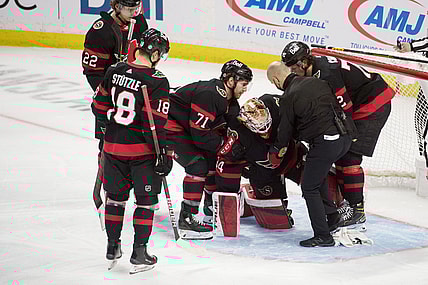 Mar 17, 2021; Ottawa, Ontario, CAN; Ottawa Senators goalie Joey Daccord (34) is helped off the ice after getting injured in the third period against the Vancouver Canucks  at the Canadian Tire Centre. Mandatory Credit: Marc DesRosiers-USA TODAY Sports