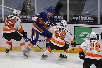 Mar 18, 2021; Uniondale, New York, USA; New York Islanders center Brock Nelson (29) fights for the puck against Philadelphia Flyers right wing Nicolas Aube-Kubel (62) and defenseman Erik Gustafsson (56) during the first period at Nassau Veterans Memorial Coliseum. Mandatory Credit: Brad Penner-USA TODAY Sports