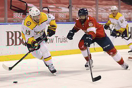 Mar 18, 2021; Sunrise, Florida, USA; Nashville Predators center Calle Jarnkrok (19) skates with the puck around Florida Panthers defenseman Radko Gudas (7) during the first period at BB&T Center. Mandatory Credit: Sam Navarro-USA TODAY Sports