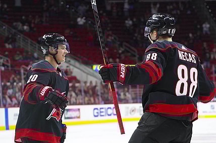 Mar 18, 2021; Raleigh, North Carolina, USA;  Carolina Hurricanes right wing Sebastian Aho (20) celebrates his second period goal with center Martin Necas (88) against the Columbus Blue Jackets at PNC Arena. Mandatory Credit: James Guillory-USA TODAY Sports