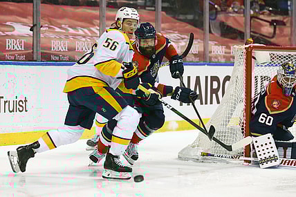 Mar 20, 2021; Sunrise, Florida, USA; Nashville Predators left wing Erik Haula (56) and Florida Panthers defenseman Radko Gudas (7) battle for the puck during the first period at BB&T Center. Mandatory Credit: Sam Navarro-USA TODAY Sports