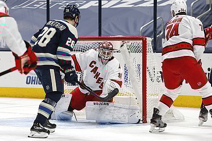 Mar 25, 2021; Columbus, Ohio, USA; Carolina Hurricanes goalie Alex Nedeljkovic (39) makes a save on a Columbus Blue Jackets center Boone Jenner (38) shot attempt during the first period at Nationwide Arena. Mandatory Credit: Russell LaBounty-USA TODAY Sports